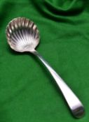 A Georgian silver sauce ladle with shell shaped bowl and decorated handle. Hallmarked London