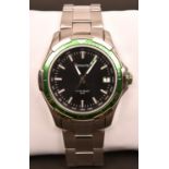 An Accurist MB907GB watch with quartz movement. Black and metallic green face with date display.