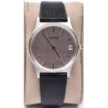 A Roamer dress watch with manual winding mechanism. Stainless steel case, metallic face and