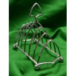 A 7-bar silver toast rack with simple gothic arches. Hallmarked Sheffield, 'J.H.P'. VGC. 207g. £50-