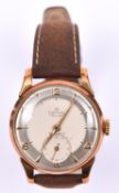 A Smiths De Luxe watch with manual winding mechanism. With metallic silvered face and gold arabic