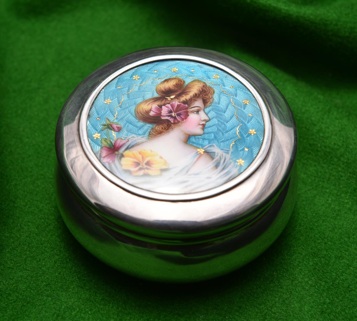 A silver round pot with removable lid and gilt washed interior. Engine turned enamel lid with a