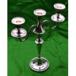 A silver candelabra with two arms and 3 removable sconces. Circular base, octagonal faceted base,