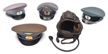 A post WWII Russian tank crew helmet with earphones; a Soviet Army officer’s peaked cap; 2 East