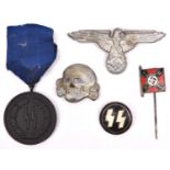 A Third Reich 4 Year Service in the SS medal, SS cap eagle, skull, circular lapel badge and