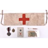 A WWI German Red Cross armband, 1914-18 Cross, Red Cross notebook and 2 other items. GC (5) £50-60