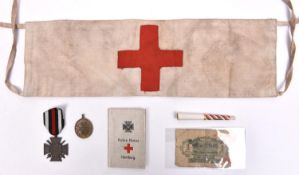 A WWI German Red Cross armband, 1914-18 Cross, Red Cross notebook and 2 other items. GC (5) £50-60