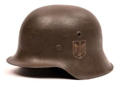 A Third Reich M42 single decal steel helmet, the skull with rough dark grey finish and eagle