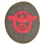 A Third Reich red on khaki embroidered cloth oval arm patch for Municipal Police, with turned over
