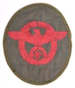 A Third Reich red on khaki embroidered cloth oval arm patch for Municipal Police, with turned over