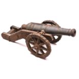 An antique model of a 17th century cannon, 28" overall, iron barrel 19", cast iron carriage and