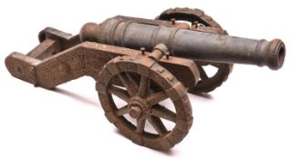 An antique model of a 17th century cannon, 28" overall, iron barrel 19", cast iron carriage and