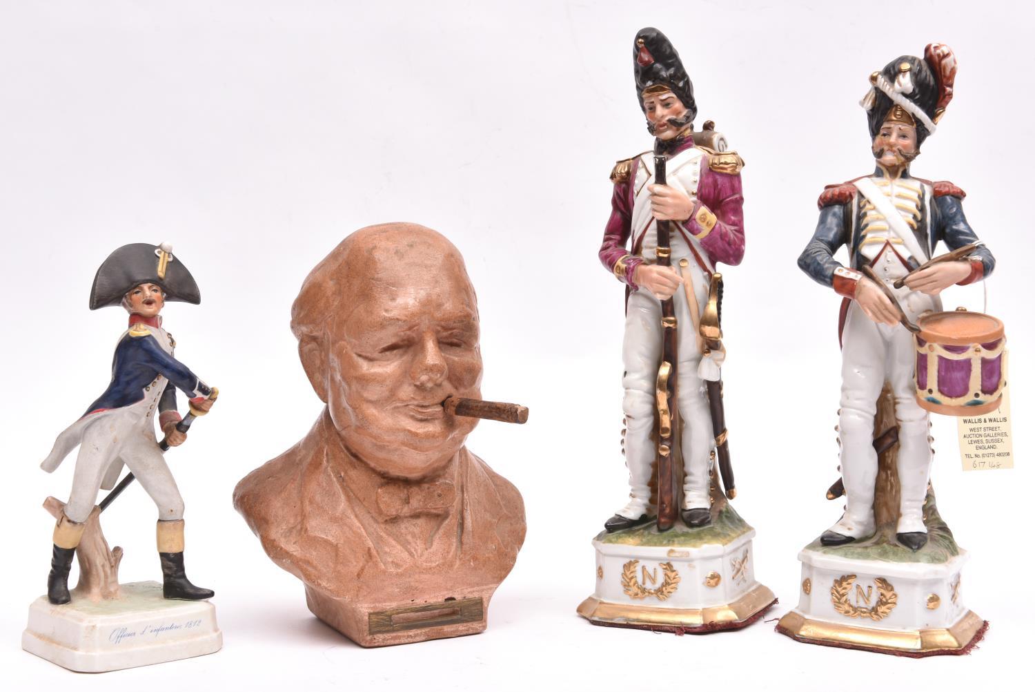 A pair of glazed porcelain figures of Napoleonic French soldiers, comprising a drummer and an