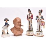 A pair of glazed porcelain figures of Napoleonic French soldiers, comprising a drummer and an