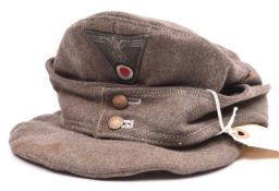 A Third Reich grey cloth soft peaked cap, with BeVo woven one piece eagle and cockade on green