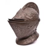 A good old cast iron copy of a late 16th century close helmet, with two piece hinged vizor, finely