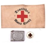 A Third Reich Red Cross man’s belt buckle, and an armband printed with “DEUTSCHES ROTES KREUZ”, also