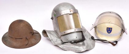 A German fireman”s type steel helmet, with face visor and fleur de lys transfer badge; a Bells