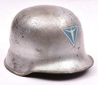 A Third Reich Police steel combat helmet, the skull painted silver over the original very worn black
