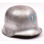 A Third Reich Police steel combat helmet, the skull painted silver over the original very worn black