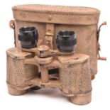 A Third Reich binocular, with eagle stamp and maker’s code “cog”, with sand coloured camouflage