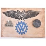 A Third Reich VW factory Luftschutz bund, printed armband; a Volkswagen 1938 pin badge and one other