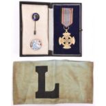 A Third Reich R.L.B. Cross of Bravery, with ribbon and in case of issue; 2 other R.L.B. badges and a