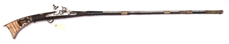 An Arab flintlock jezail, 60" overall, barrel 44½”, wood and bone stock, metal mounts GC (lock
