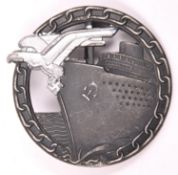 A Third Reich Blockade Runners badge, alloy finish eagle, blackened background, marked on reverse “