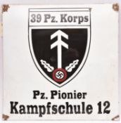 A black on white enamelled sign, bearing shield badge of “39 Pz Korps” and “Pz Pionier Kampfschule