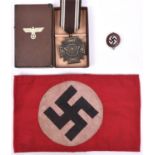 A Third Reich NSDAP LSGC in bronze, in case of issue; an arm band and a party badge. GC (3) £50-80