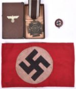 A Third Reich NSDAP LSGC in bronze, in case of issue; an arm band and a party badge. GC (3) £50-80