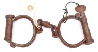 A good pair of Victorian plug lock handcuffs, marked “HIATT BEST WARRENTED WROUGHT 457”, complete