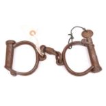 A good pair of Victorian plug lock handcuffs, marked “HIATT BEST WARRENTED WROUGHT 457”, complete