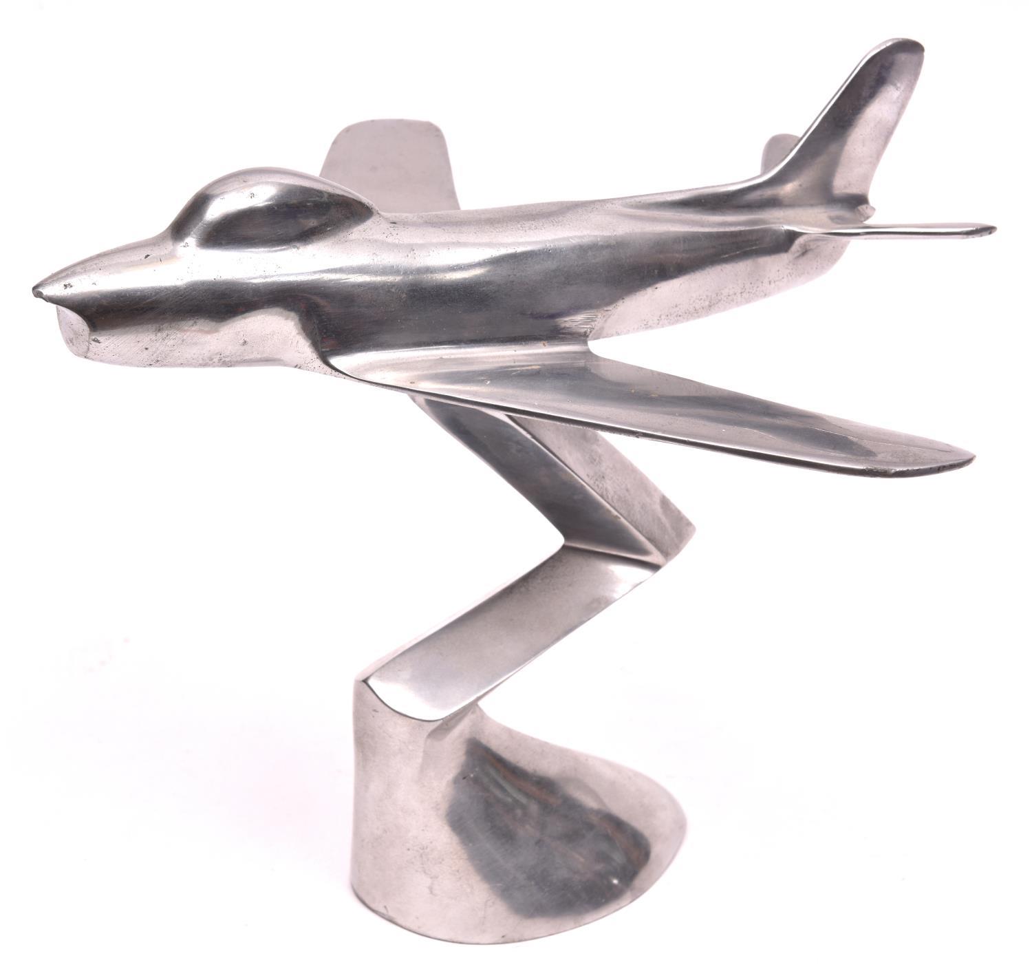 An F86 sabre jet aircraft desk model, made of stainless steel, 9" high, 10" long. GC £10-20