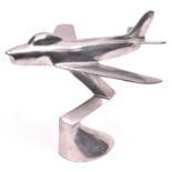 An F86 sabre jet aircraft desk model, made of stainless steel, 9" high, 10" long. GC £10-20