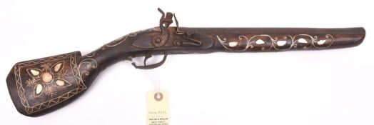 A decorative Indian bazaar “flintlock” pistol, 21½” overall, with wire and M.O.P. inlaid stock and