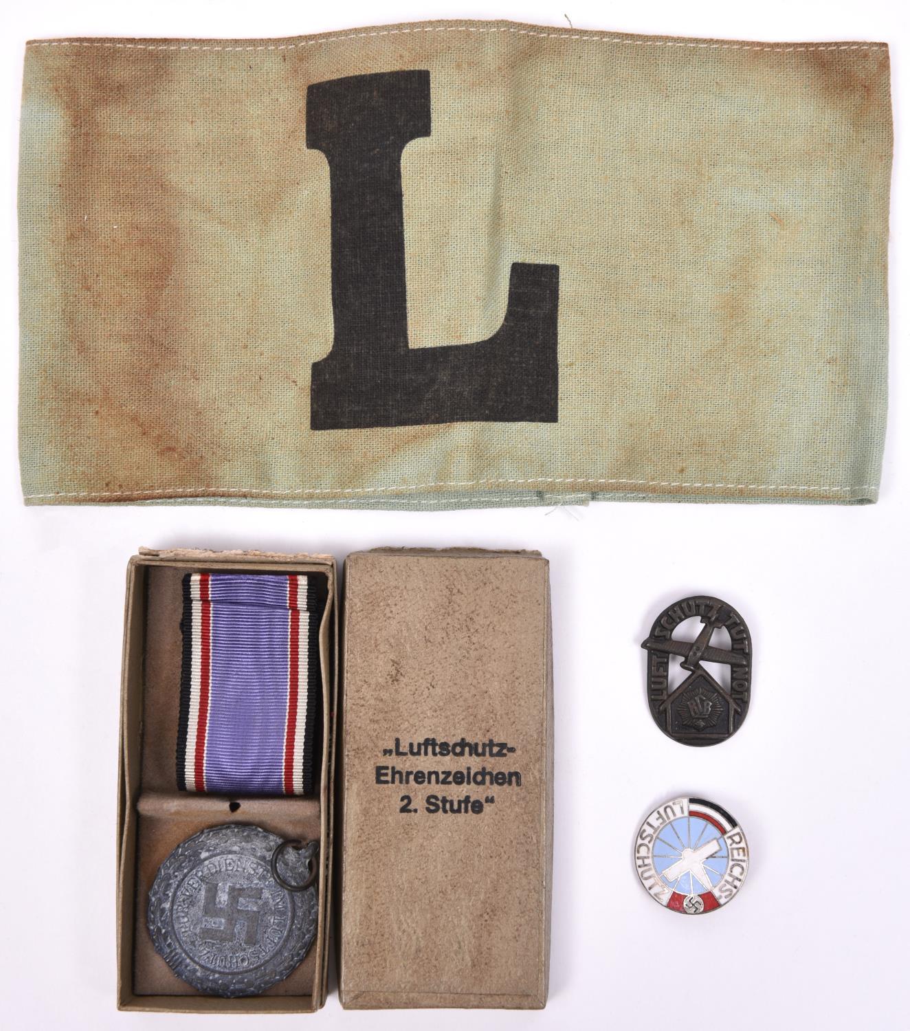 A Third Reich Luftschutz medal, with ribbon, in case of issue; 2 other Luftschutz badges, and a