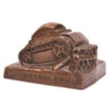 A heavy hand finished cast bronze desk paperweight, in the form of a tank surmounting an obstacle,