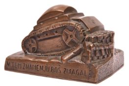 A heavy hand finished cast bronze desk paperweight, in the form of a tank surmounting an obstacle,