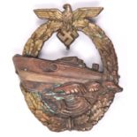 A Third Reich E Boat war badge, bronzed E boat, brass coloured wreath, marked on reverse “FEC E