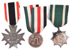 A Third Reich War Service cross with swords, an Eastern Peoples medal and a D.A.K medal, All with