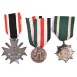 A Third Reich War Service cross with swords, an Eastern Peoples medal and a D.A.K medal, All with