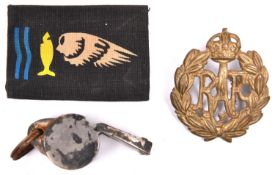 A printed cloth badge of the Goldfish Sea Rescue; an RAF cap badge and an Air Ministry marked