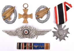 A Third Reich Luftwaffe NCO’s cap cockade (one pin missing); grey metal War Merit Cross 2nd class
