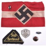 A Third Reich Hitler Youth armband and enamel badge; an embroidered “Sud Hochland” triangular badge;