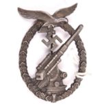 A Third Reich Luftwaffe Anti Aircraft Gunners badge, bronzed finish, marked on reverse “B&N” over “