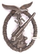 A Third Reich Luftwaffe Anti Aircraft Gunners badge, bronzed finish, marked on reverse “B&N” over “