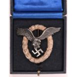 A Third Reich Luftwaffe pilot’s breast badge, alloy wreath with silvered eagle, marked on back