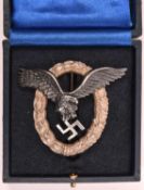 A Third Reich Luftwaffe pilot’s breast badge, alloy wreath with silvered eagle, marked on back